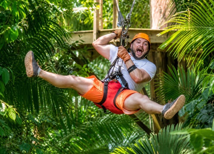 Guest ziplining through the Belize rainforest on Xunantunich, Cave Tubing and Ziplining from Caye Caulker