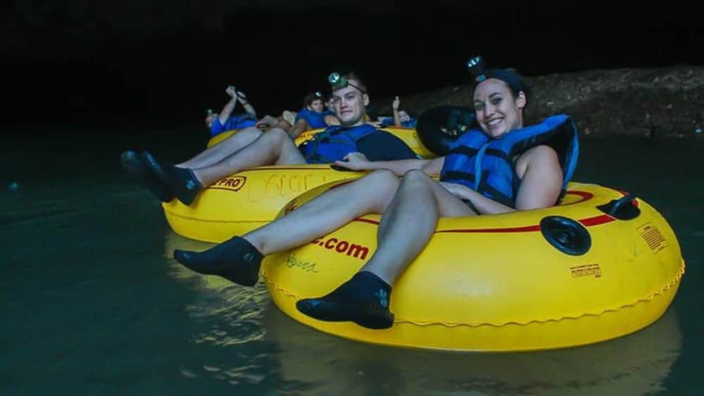 Guests cave tubing through Belize river caves on Private Cave Tubing Tour From Belize City